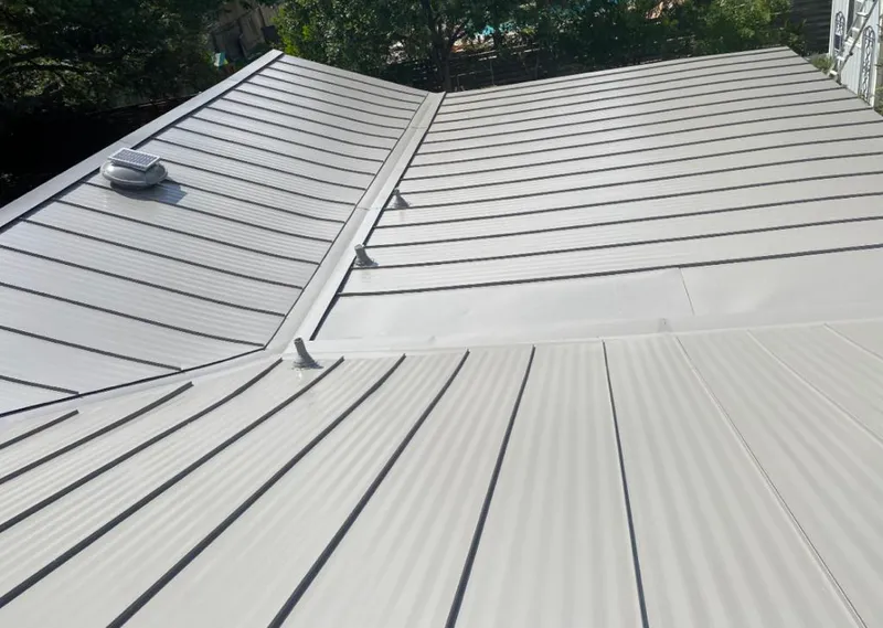 Solar attic fan installed on a metal roof for Roof Ventilation in Gig Harbor